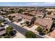 Aerial view of a well-maintained home in a suburban neighborhood, featuring a manicured lawn and mature trees at 21030 E Misty Ln, Queen Creek, AZ 85142