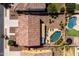 Backyard retreat boasting a glistening pool, verdant landscaping, and a relaxing lounge area at 21030 E Misty Ln, Queen Creek, AZ 85142