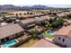 Expansive aerial view of a home with a beautiful backyard pool and meticulously landscaped backyard and nearby homes at 21030 E Misty Ln, Queen Creek, AZ 85142