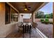 Covered back patio with a ceiling fan, dining area, and comfortable seating, perfect for relaxing and entertaining at 21030 E Misty Ln, Queen Creek, AZ 85142