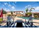 This backyard boasts a pool, mature landscaping, an umbrella, and an outdoor fire pit at 21030 E Misty Ln, Queen Creek, AZ 85142