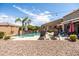 Expansive backyard with a sparkling pool, mature landscaping, and ample space for outdoor activities at 21030 E Misty Ln, Queen Creek, AZ 85142