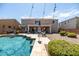 Inviting backyard with a sparkling pool, string lights, comfortable lounge chairs, and shade umbrellas at 21030 E Misty Ln, Queen Creek, AZ 85142