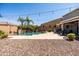 Backyard features a refreshing pool with a waterfall, desert landscaping, and an outdoor dining area at 21030 E Misty Ln, Queen Creek, AZ 85142