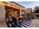 Cozy backyard with a covered patio, a fire pit, and comfortable seating, creating an inviting outdoor retreat at 21030 E Misty Ln, Queen Creek, AZ 85142