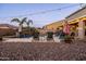 Relaxing backyard oasis with palm trees, outdoor seating, string lights, and a refreshing pool for leisure and enjoyment at 21030 E Misty Ln, Queen Creek, AZ 85142