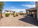 Large backyard with a covered patio, lounge area, mature landscaping, and room to entertain at 21030 E Misty Ln, Queen Creek, AZ 85142