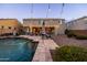 Inviting backyard featuring a pool, stylish patio furniture, and string lights, perfect for outdoor entertaining at 21030 E Misty Ln, Queen Creek, AZ 85142