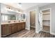 Spacious bathroom with a dual sink vanity, modern fixtures, and wood plank flooring at 21030 E Misty Ln, Queen Creek, AZ 85142