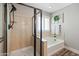 Bathroom featuring a soaking tub, a separate tiled shower with glass door, and a shuttered window at 21030 E Misty Ln, Queen Creek, AZ 85142