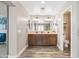 Bathroom with double vanity and ample cabinet space, with view to the shower and toilet at 21030 E Misty Ln, Queen Creek, AZ 85142