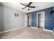 Bedroom featuring neutral walls, closet, ceiling fan, and a door leading to the hallway at 21030 E Misty Ln, Queen Creek, AZ 85142
