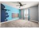 Bedroom showcasing custom paint with a pop of color, ceiling fan, and bright window at 21030 E Misty Ln, Queen Creek, AZ 85142