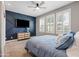 Stylish bedroom featuring a blue accent wall, modern furniture, and natural light at 21030 E Misty Ln, Queen Creek, AZ 85142