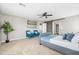 Large primary bedroom boasts comfortable seating area, accent wall, and cozy carpet at 21030 E Misty Ln, Queen Creek, AZ 85142