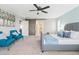 Bright primary bedroom with sliding barn door entry to the ensuite bathroom and walk in closet at 21030 E Misty Ln, Queen Creek, AZ 85142