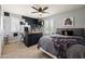 This bedroom features neutral paint, shutters, a ceiling fan, and reptile terrarium at 21030 E Misty Ln, Queen Creek, AZ 85142