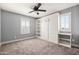 Comfortable bedroom with a modern Murphy bed, shelving, and natural light from windows at 21030 E Misty Ln, Queen Creek, AZ 85142