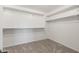 Walk-in closet with carpeted floor and white shelving system at 21030 E Misty Ln, Queen Creek, AZ 85142