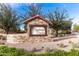 Stone Hastings Farms community sign with tile roof and manicured landscaping at 21030 E Misty Ln, Queen Creek, AZ 85142