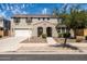 Charming two-story home featuring a two-car garage, landscaped yard, and a welcoming front porch at 21030 E Misty Ln, Queen Creek, AZ 85142