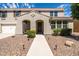 Charming home with beautiful landscaping, a two-car garage, and a welcoming front porch at 21030 E Misty Ln, Queen Creek, AZ 85142