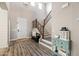 Bright foyer with hardwood floors, staircase, and elegant decor creating a warm welcome at 21030 E Misty Ln, Queen Creek, AZ 85142