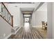 Bright foyer features wood-look floors, stairs with iron spindles, and access to the dining room at 21030 E Misty Ln, Queen Creek, AZ 85142