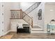 Elegant foyer with wood flooring, staircase with iron railing, and decorative accents at 21030 E Misty Ln, Queen Creek, AZ 85142