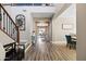 Spacious foyer with wood flooring, staircase, and views into the dining area at 21030 E Misty Ln, Queen Creek, AZ 85142