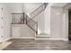 Foyer showcasing staircase with wood and iron spindles, closet under stairs, and wood-look floors at 21030 E Misty Ln, Queen Creek, AZ 85142