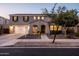 Charming two-story home with a well-manicured front yard, a two-car garage, and inviting curb appeal at 21030 E Misty Ln, Queen Creek, AZ 85142