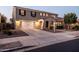 Charming two-story home featuring a well-kept front yard, two-car garage, and appealing architectural details at 21030 E Misty Ln, Queen Creek, AZ 85142