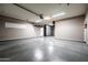Spacious garage with epoxy flooring, built-in storage cabinets, and ample room for parking and projects at 21030 E Misty Ln, Queen Creek, AZ 85142