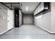 Spacious garage with epoxy floors, storage cabinets, and overhead racks providing ample organization at 21030 E Misty Ln, Queen Creek, AZ 85142