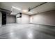Clean garage with epoxy flooring, overhead storage, and built-in cabinets to organize and maximize space at 21030 E Misty Ln, Queen Creek, AZ 85142