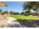 Large community greenspace surrounded by mature landscaping, a paved pathway, and shady trees at 21030 E Misty Ln, Queen Creek, AZ 85142