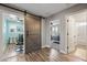 Hallway featuring a barn door to a laundry room and entrance to main bedroom at 21030 E Misty Ln, Queen Creek, AZ 85142