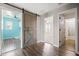 Hallway featuring wood-look floors, barn door and easy access to the adjacent rooms at 21030 E Misty Ln, Queen Creek, AZ 85142