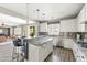 Well-lit kitchen featuring white cabinets, granite counters, stainless steel appliances, and island with seating at 21030 E Misty Ln, Queen Creek, AZ 85142