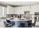 Stylish kitchen showcasing a circular island with bar stools, granite counters, modern appliances and gray backsplash at 21030 E Misty Ln, Queen Creek, AZ 85142