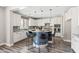 Modern kitchen with a unique island featuring bar stool seating, complemented by sleek countertops and cabinetry at 21030 E Misty Ln, Queen Creek, AZ 85142