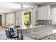 Bright kitchen with granite countertops, stainless steel appliances, and a charming breakfast bar overlooking the backyard at 21030 E Misty Ln, Queen Creek, AZ 85142