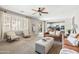 Inviting living room with neutral tones, plush seating, and a seamless flow to the kitchen area at 21030 E Misty Ln, Queen Creek, AZ 85142