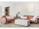 Comfortable seating arrangement with leather sofas, an ottoman, and neutral decor creates a relaxing living space at 21030 E Misty Ln, Queen Creek, AZ 85142