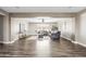 Open living area showcasing hardwood floors, neutral color scheme, and easy access to other parts of the home at 21030 E Misty Ln, Queen Creek, AZ 85142