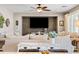 A cozy living room features a ceiling fan, a shiplap accent wall, and neutral furniture at 21030 E Misty Ln, Queen Creek, AZ 85142