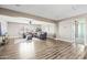 Spacious living area featuring hardwood floors, ample natural light, and comfortable seating for relaxation at 21030 E Misty Ln, Queen Creek, AZ 85142