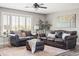 Comfortable living room with sofas, ottoman, and natural light from the large window at 21030 E Misty Ln, Queen Creek, AZ 85142