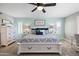 Bright main bedroom with light blue accent wall, white furnishings, carpet, and plantation shutters at 21030 E Misty Ln, Queen Creek, AZ 85142